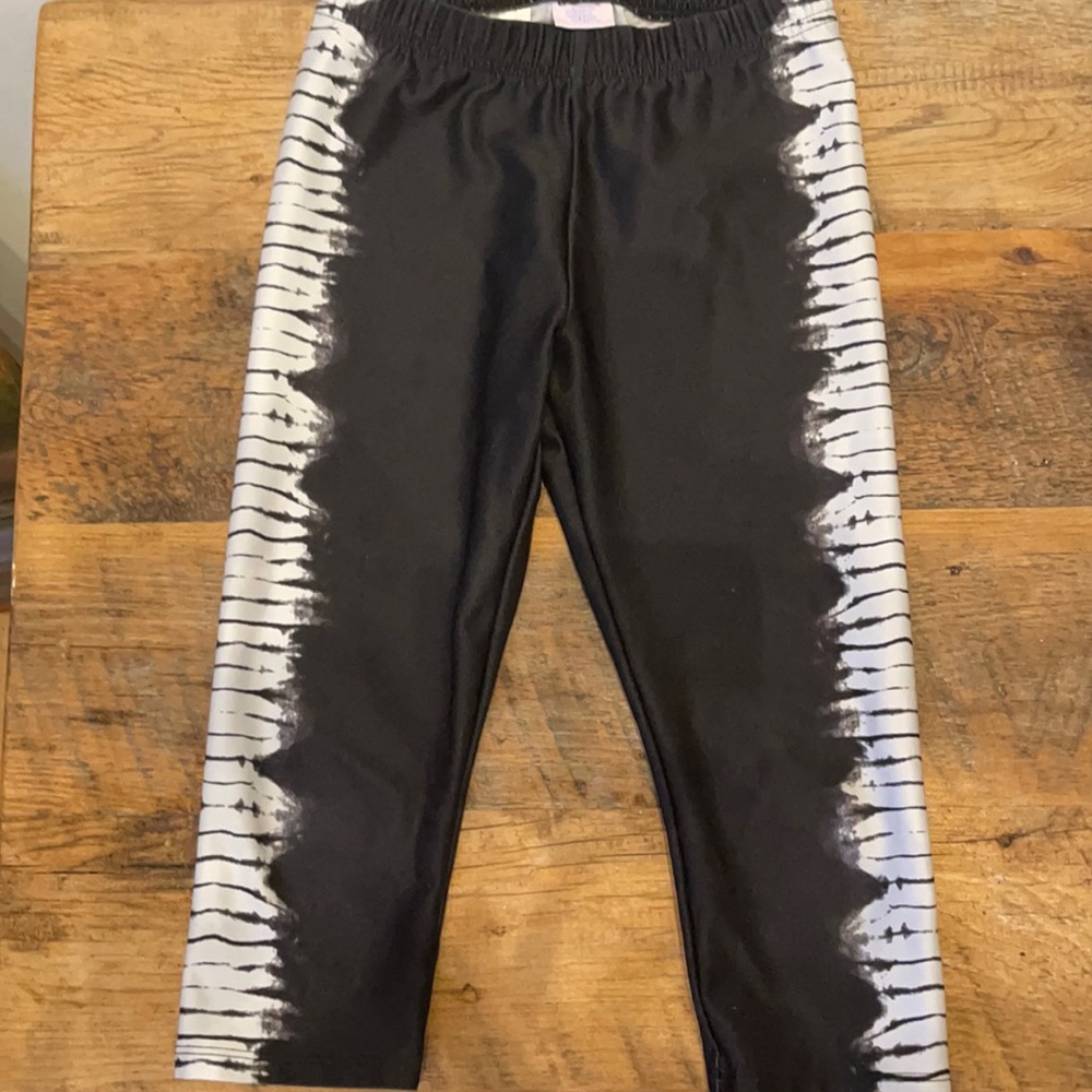 Black capris with tie dye down sides by More Than Magic